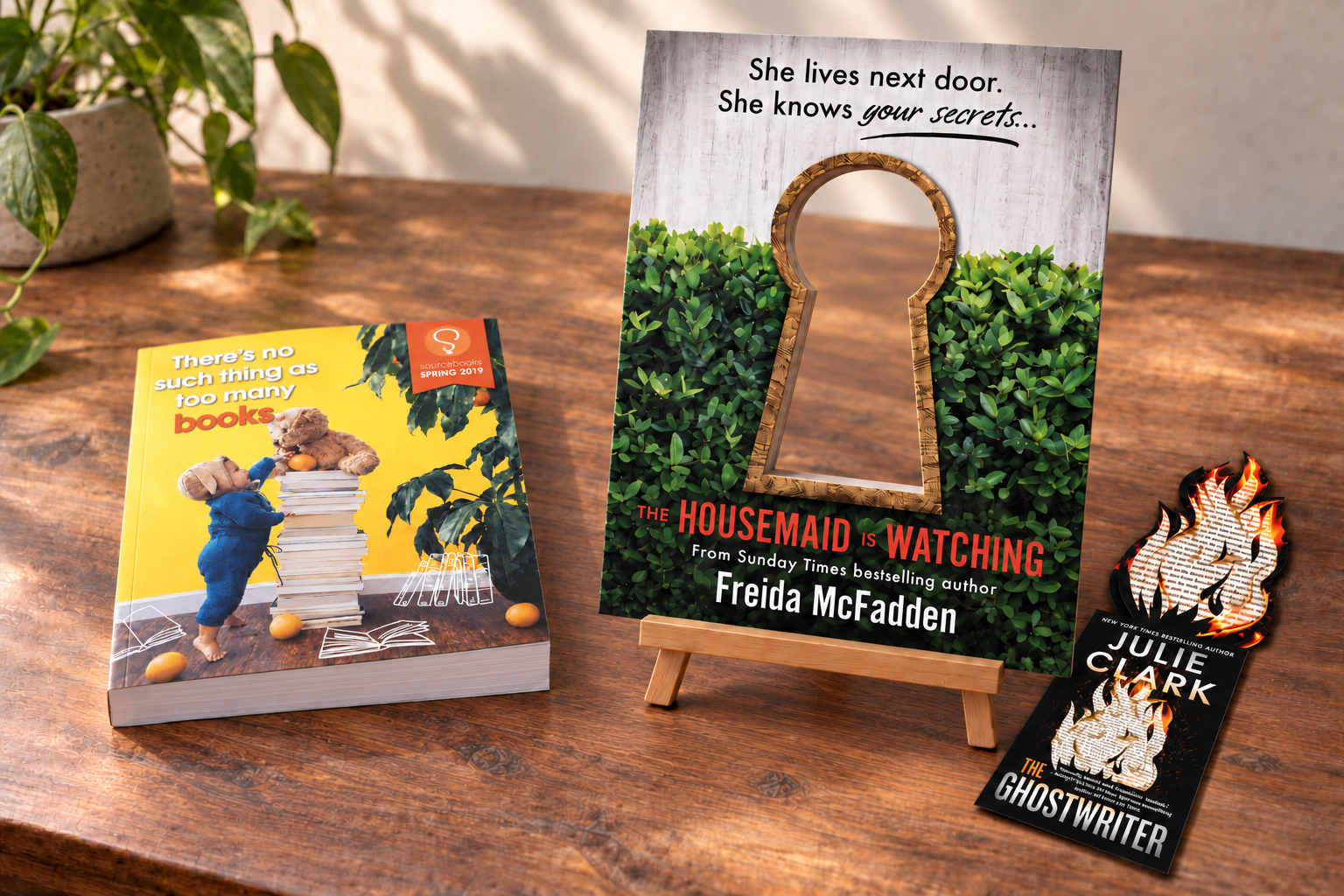 Equally scaled catalog and die-cut keyhole easel with a complete Ghostwriter bookmark on a wooden desk